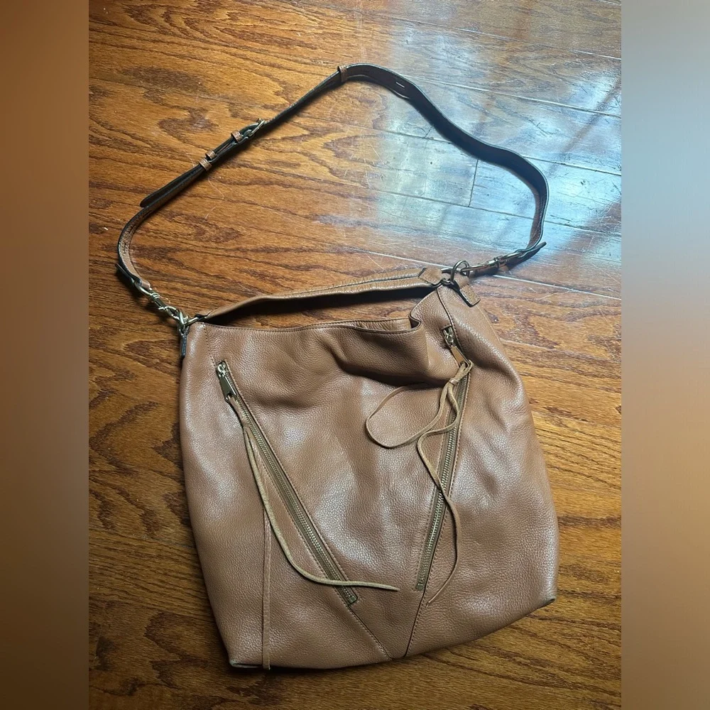 Rebecca Minkoff Moto hobo bag featuring prominent vertical zippers on the front.